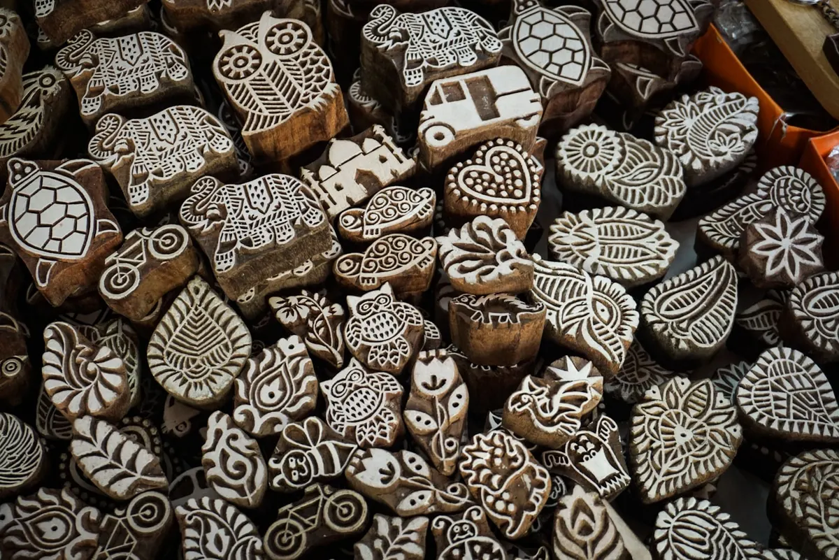 Carved teak printing blocks laid out in a workshop