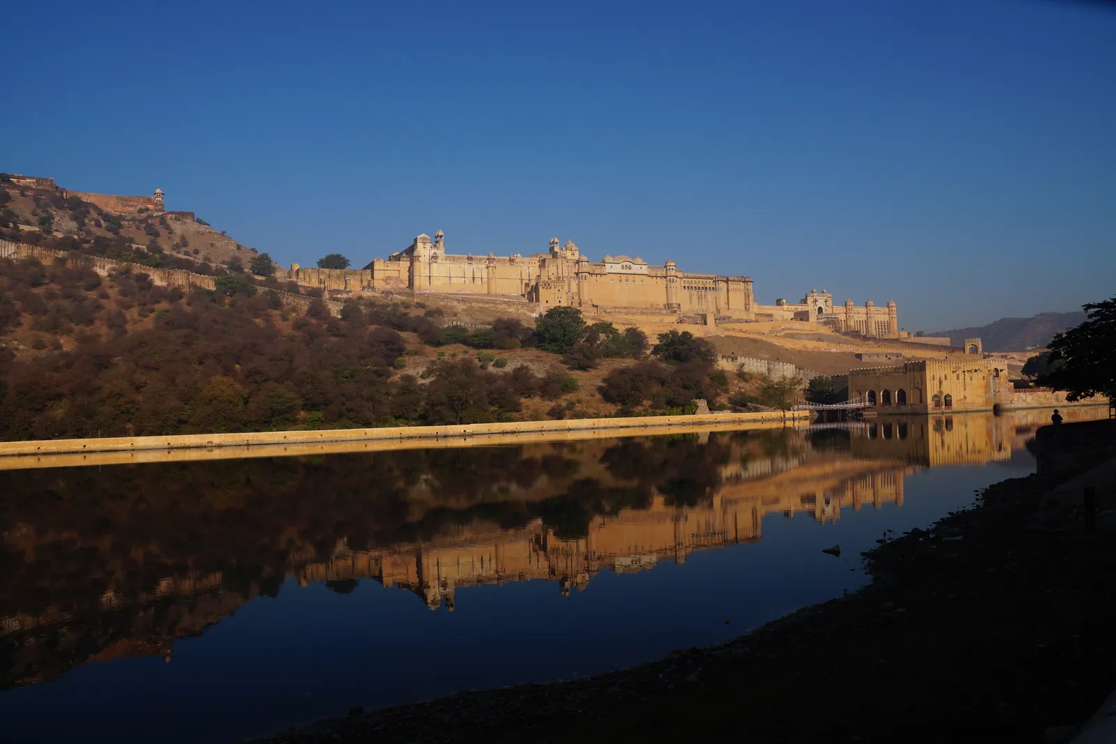 Amber Fort at first light, reflected in a still lake, nobody on the water